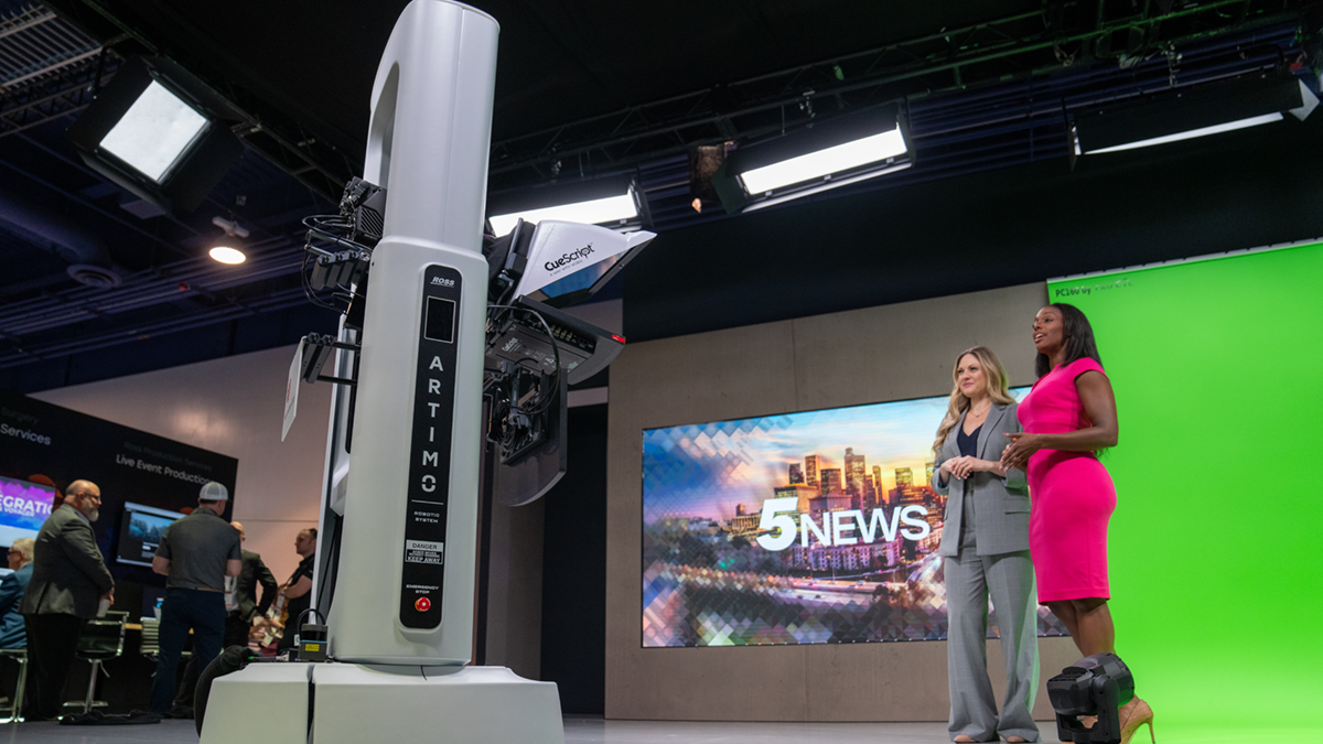 Ross Video robotic camera in a green screen studio with two women newscasters.