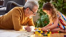 Man playing a game with a grandchild