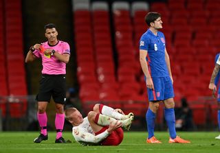 Harry Maguire, right, reacts after being sent off