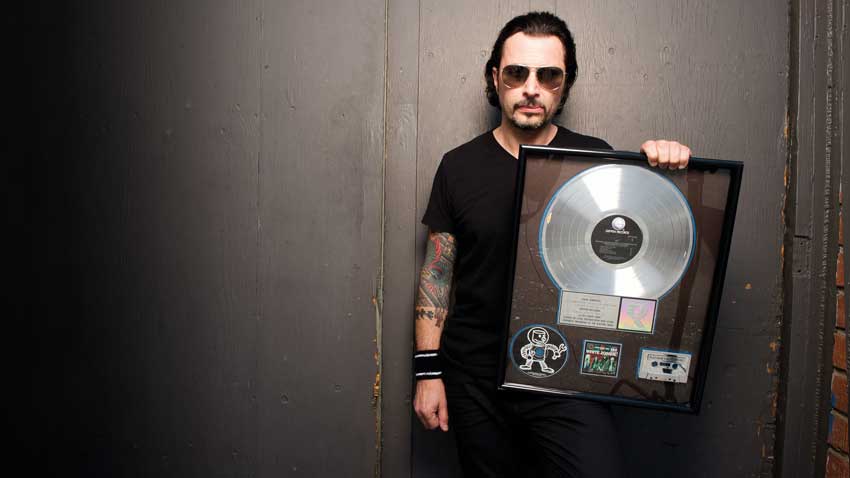 The former White Zombie drummer with his platinum disc for Astro Creep: 2000