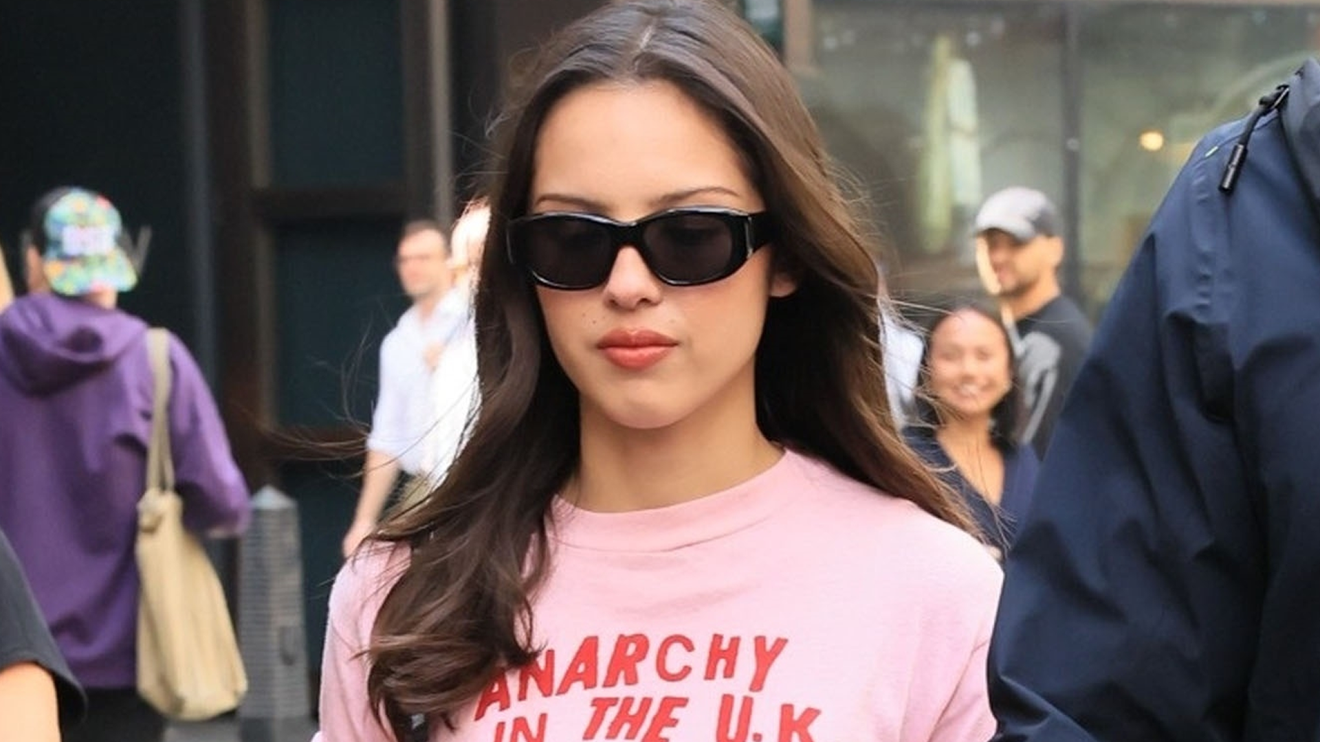 Olivia Rodrigo wore a graphic tee and leather mini skirt with an on-sale Coach bag