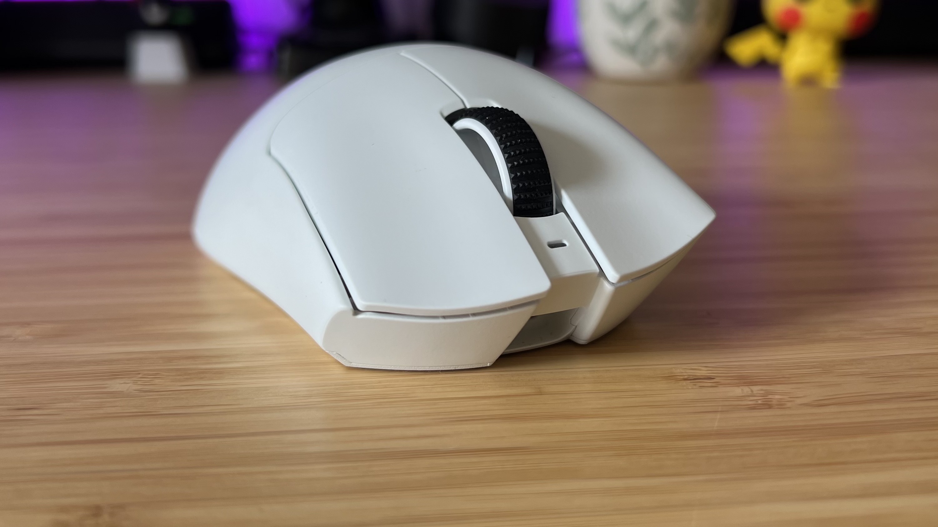 Front of Razer DeathAdder V4 Pro gaming mouse on a wooden desk