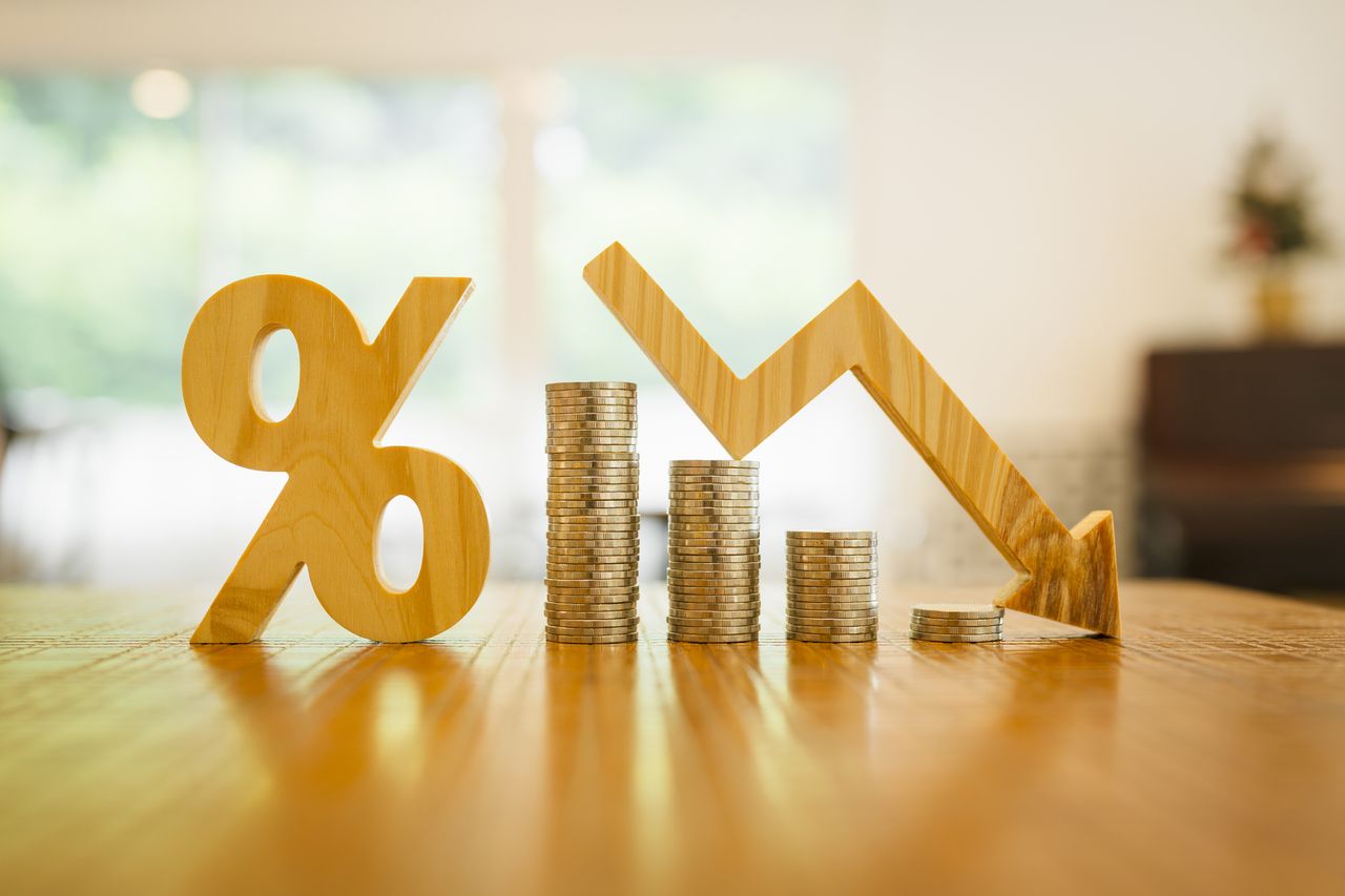 Percentage model, coin stack and down arrow, concepts for success, methods, systems of raising or lowering Fed interest rates to correct inflation concepts.