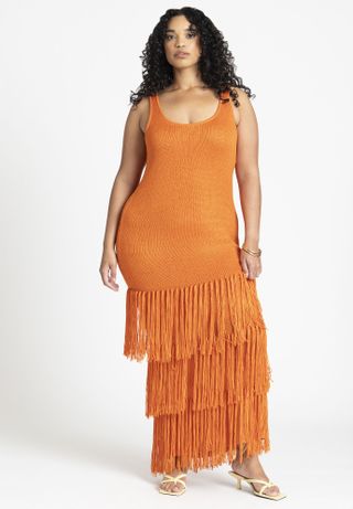 model wears orange fringed sweater dress