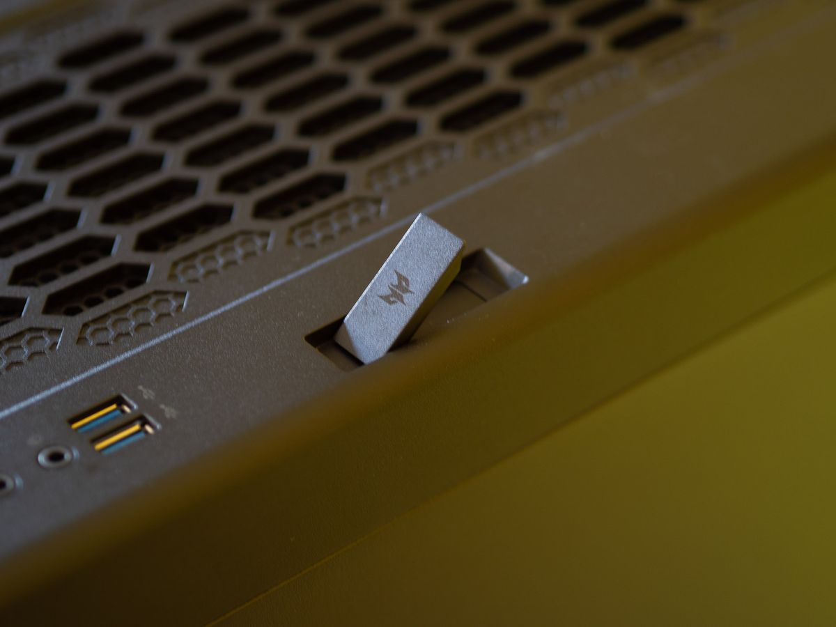Acer Predator Orion 7000 gaming desktop PC on a wooden desk and yellow background