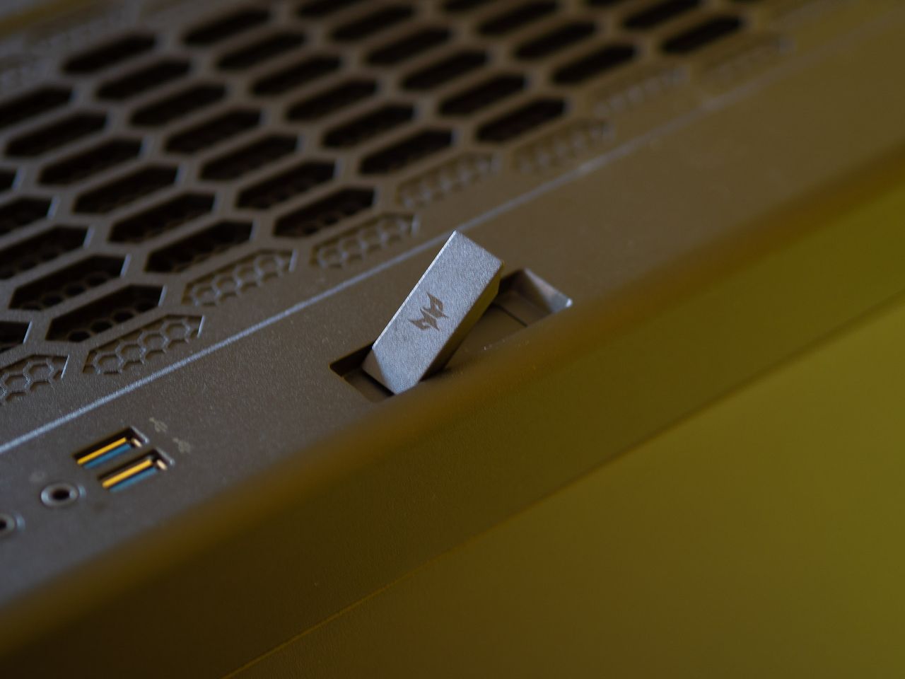 Acer Predator Orion 7000 gaming desktop PC on a wooden desk and yellow background
