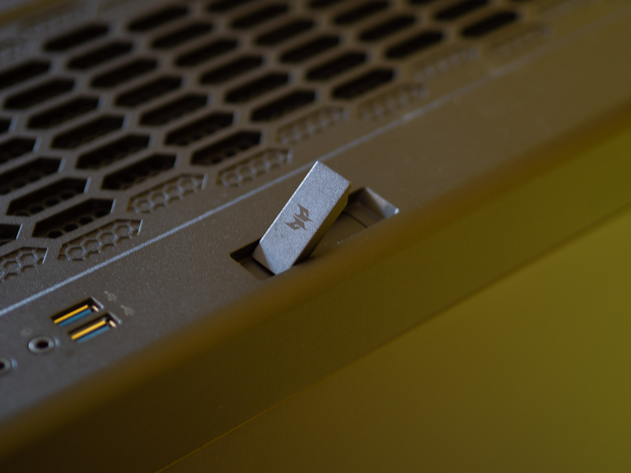 Acer Predator Orion 7000 gaming desktop PC on a wooden desk and yellow background