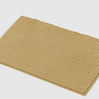 A beige bath mat