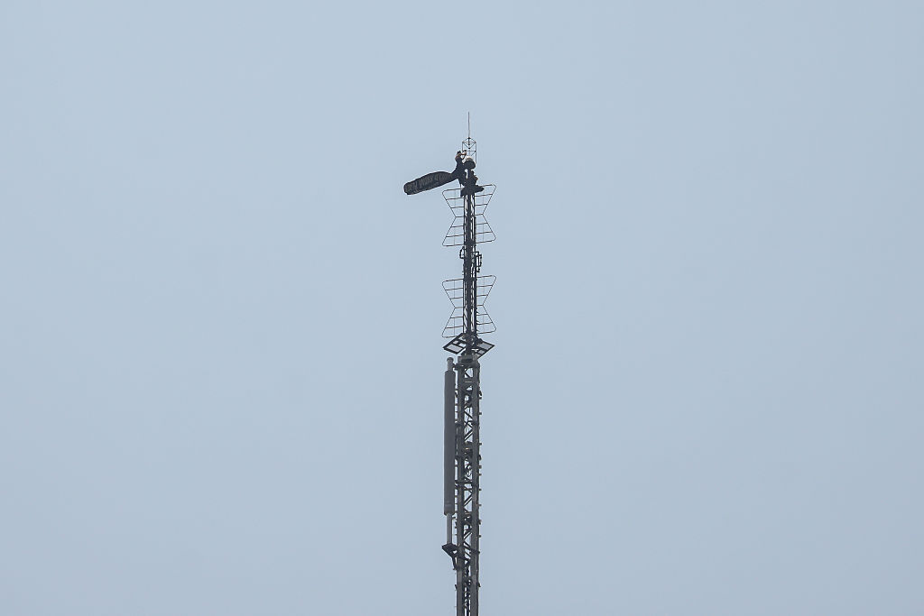 People unfurl a banner from the spire of the Empire State Building in New York, US, on Wednesday, July 1, 2026. Two people got to the top of the Empire State Building's antenna, unfurled a banner and were arrested when they descended, according to the Associated Press. Photographer: Michael Nagle/Bloomberg