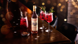 Two Lillet Winterberry Spritz cocktails pictured on a festive table