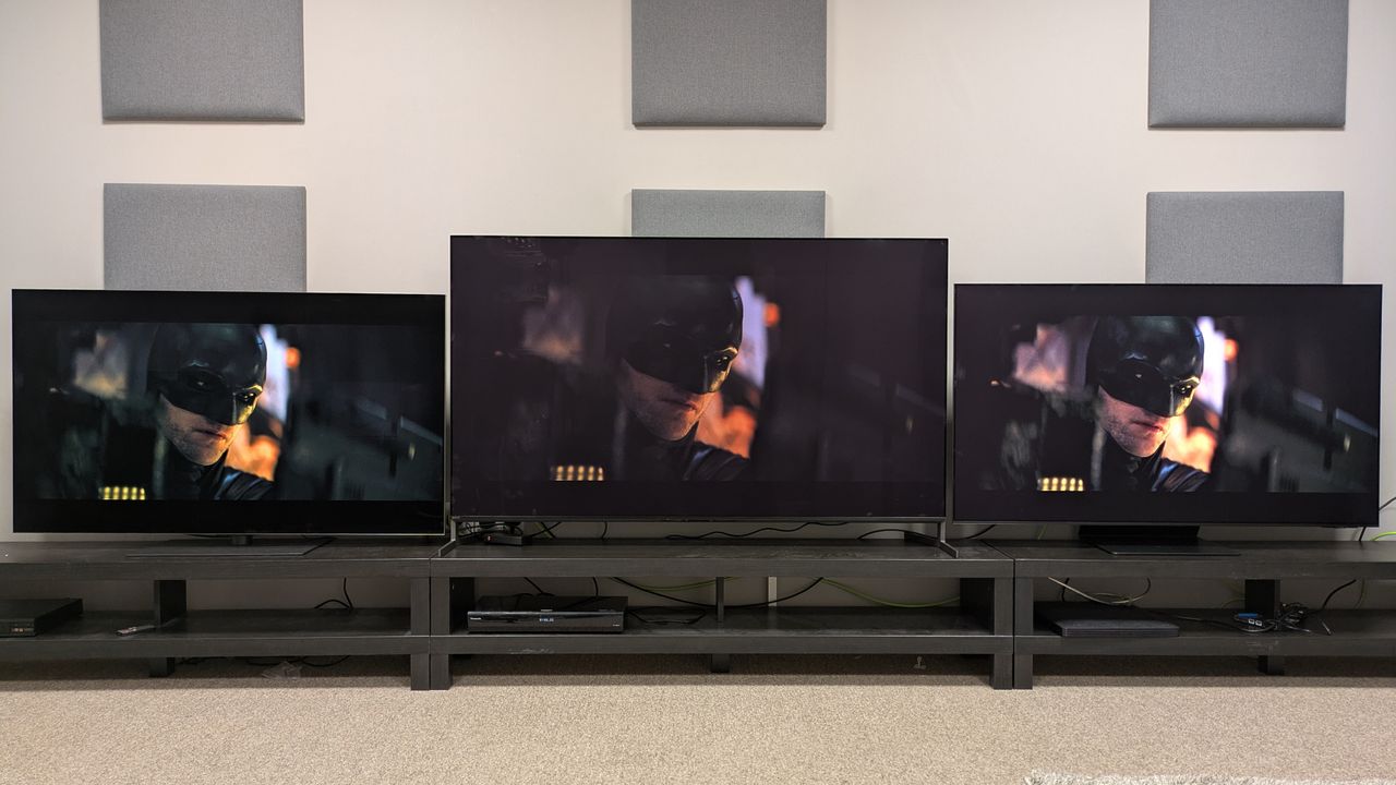 LG G5 (left) Sony Bravia 8 II (middle) and Samsung S95F (left) with face of Batman on screen from The Batman with Sony's default tone mapping setting