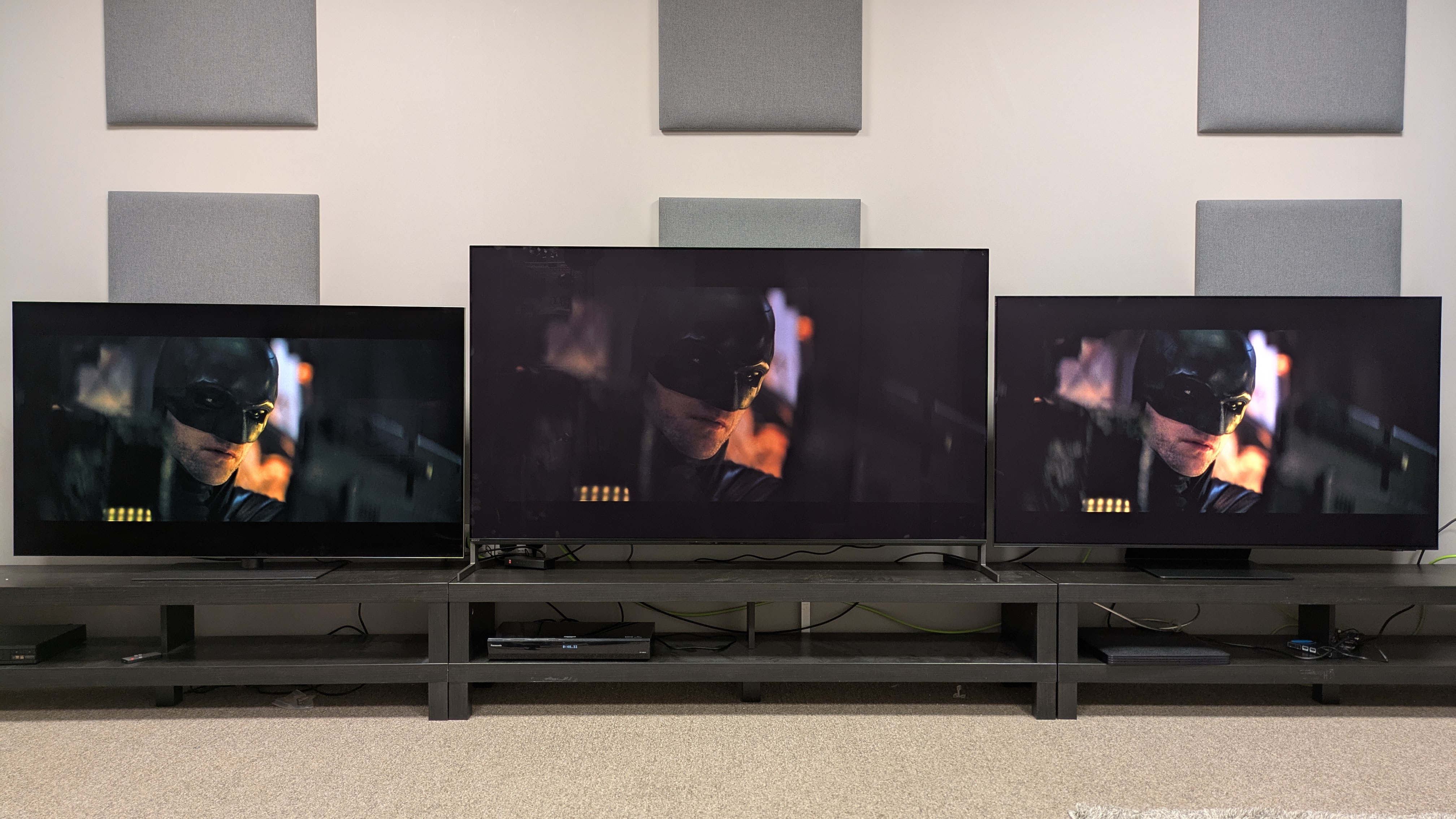 LG G5 (left) Sony Bravia 8 II (middle) and Samsung S95F (left) with face of Batman on screen from The Batman with Sony's default tone mapping setting 