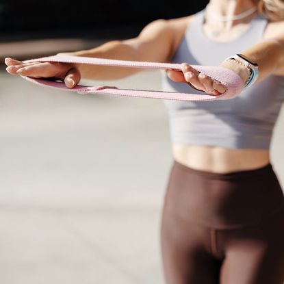 A woman doing a resistance band workout