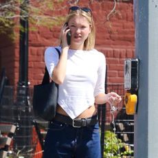 Lila Moss wears baggy jeans and ballet flats.