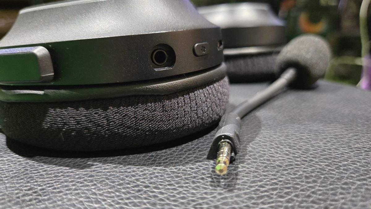 The Razer Barracuda X Chroma wireless gaming headset with a colorful finish on a chair.