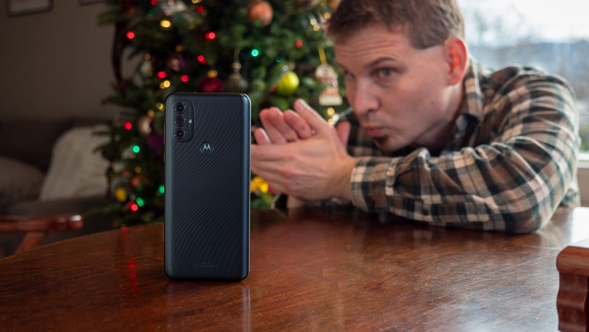 Looking greedily at the Moto G Power (2022) with Christmas Tree in the background