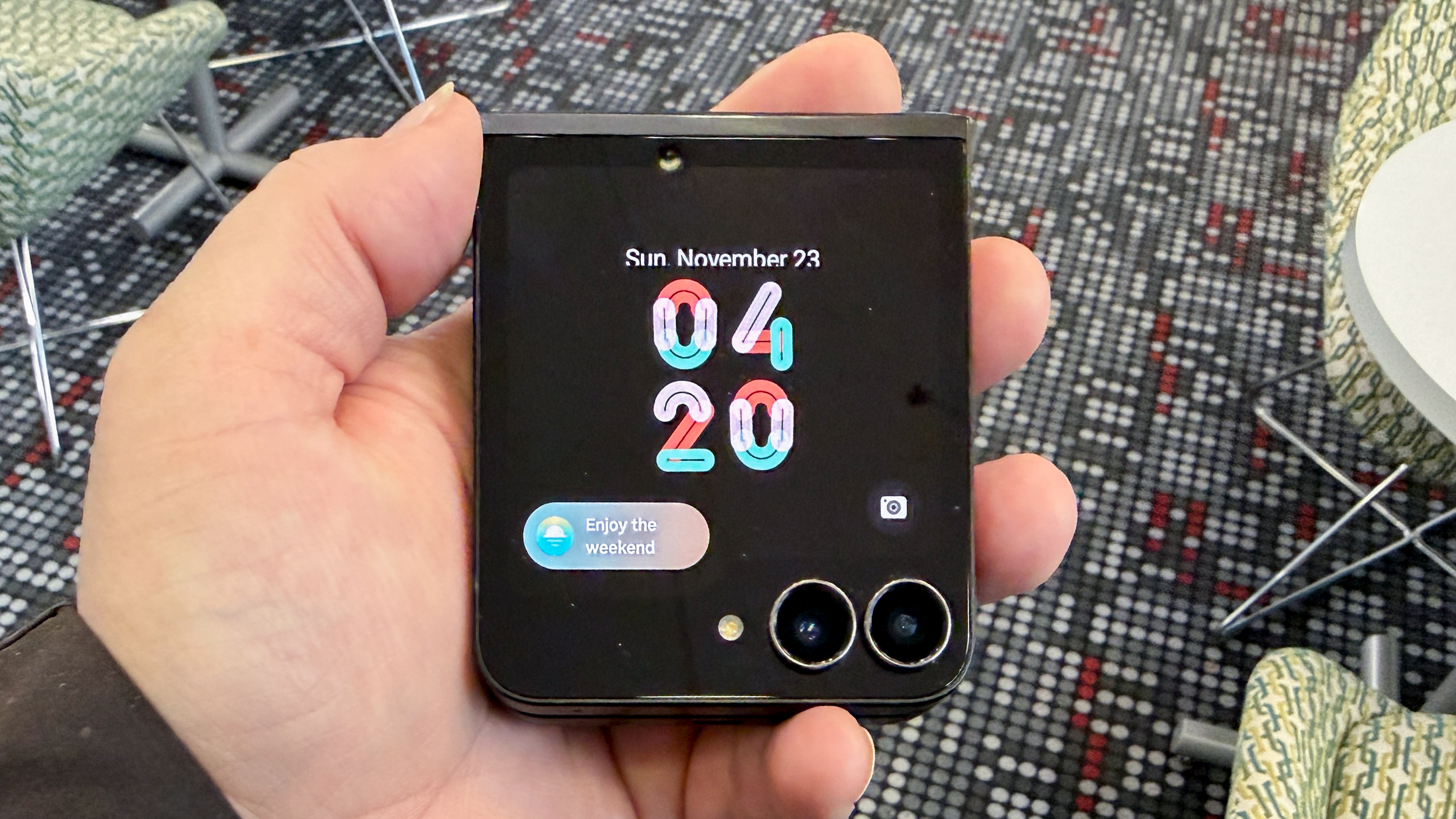 Samsung Galaxy Z Flip 7 FE in piano black color showing content on the cover display and the main screen