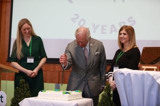 Prince Charles, Prince of Wales cuts a cake celebrating Rural Support Northern Ireland's 20th Anniversary during a visit to the College of Agriculture Food and Rural Enterprise on March 22, 2022 in in Cookstown in County Tyrone, Northern Ireland. Their Royal Highnesses are on the first day of a two day visit to the province.