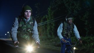 Mike and Lucas on bicycles at night in Stranger Things season 5