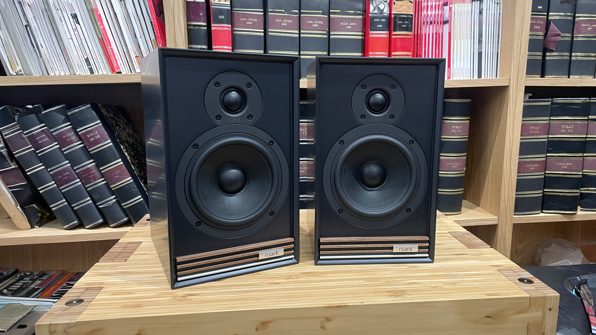 Ruark Audio Sabre-R speakers in black finish on wooden rack