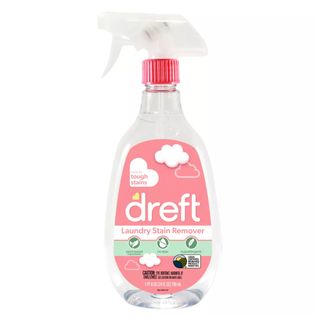 A side-on view of a clear spray trigger bottle with a pink label that says dreft laundry stain remover