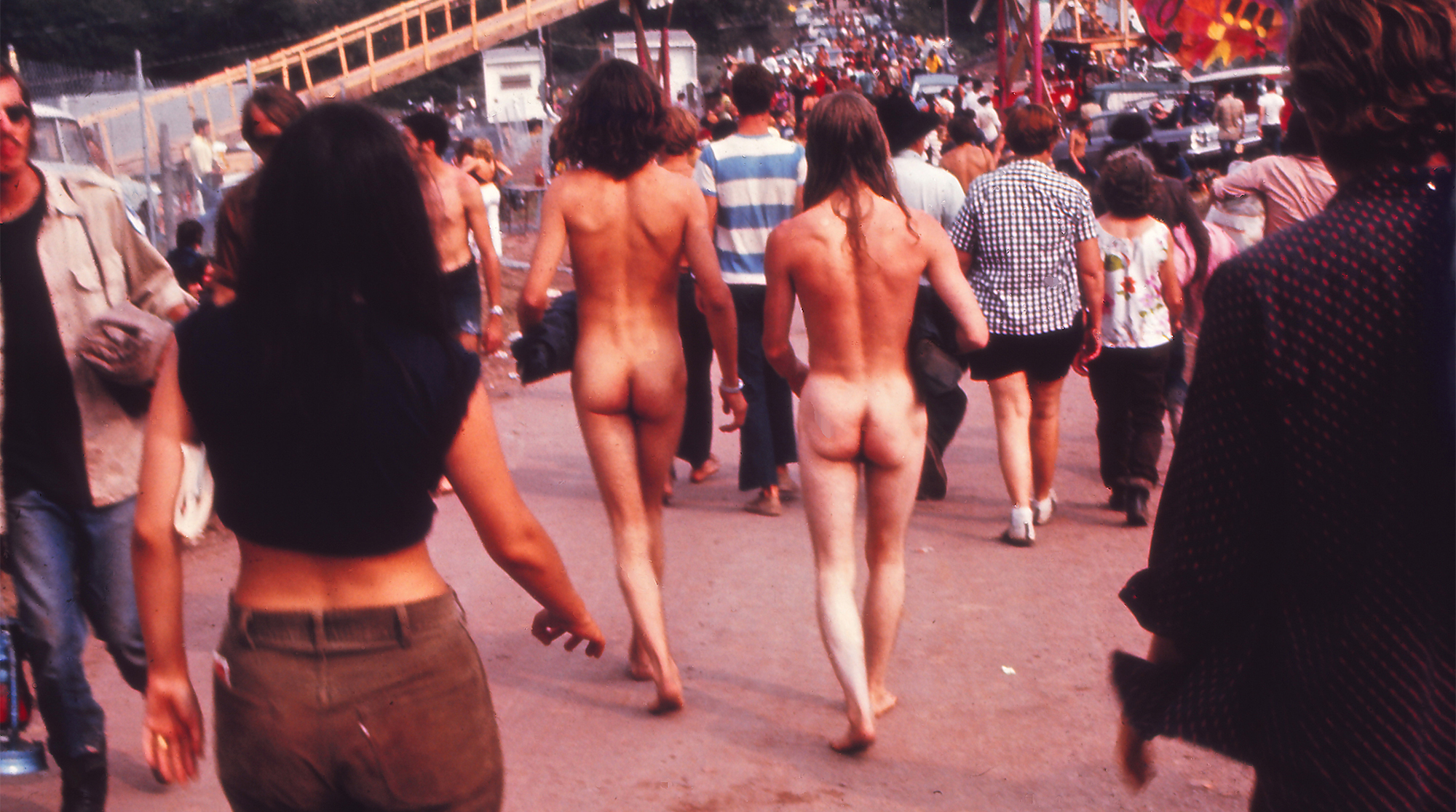 Two naked men walking toward the Music Festival, 1969