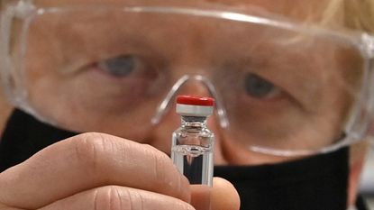 Boris Johnson with a vial of the AstraZeneca/Oxford University vaccine