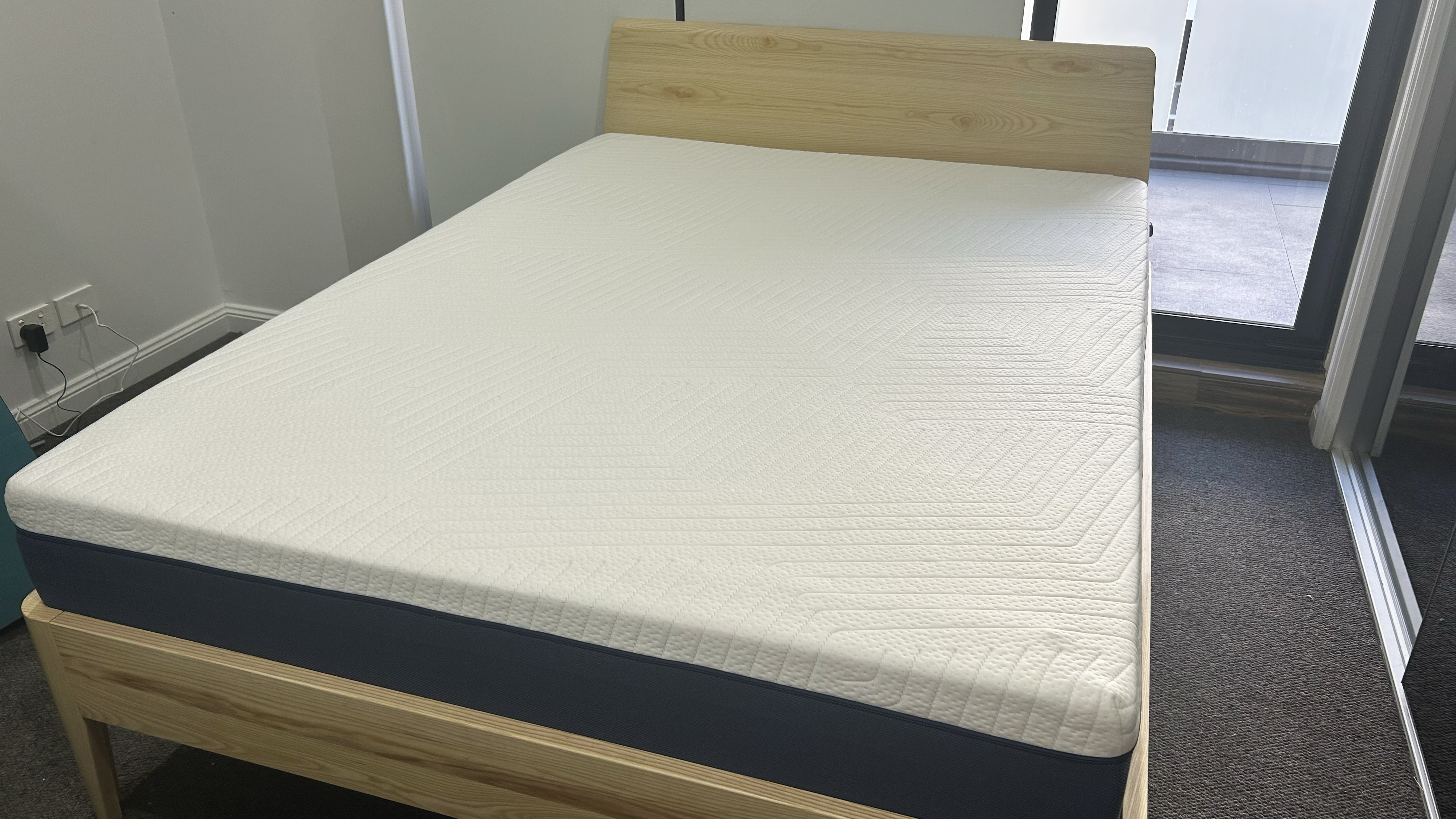 Onebed Original mattress on bedframe in room
