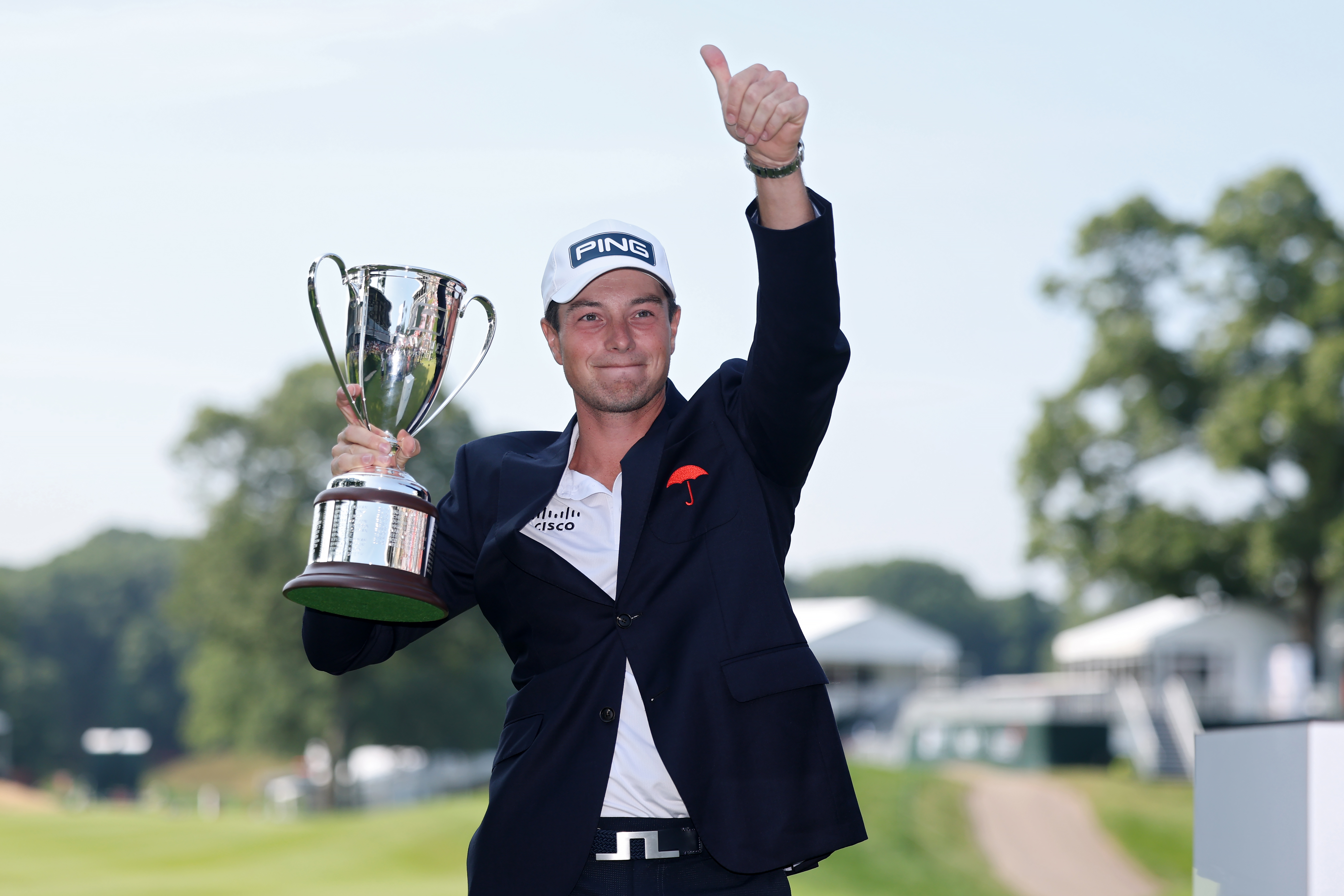 Viktor Hovland celebrates with the trophy after winning the Travelers Championship 2026 in a playoff at TPC River Highlands