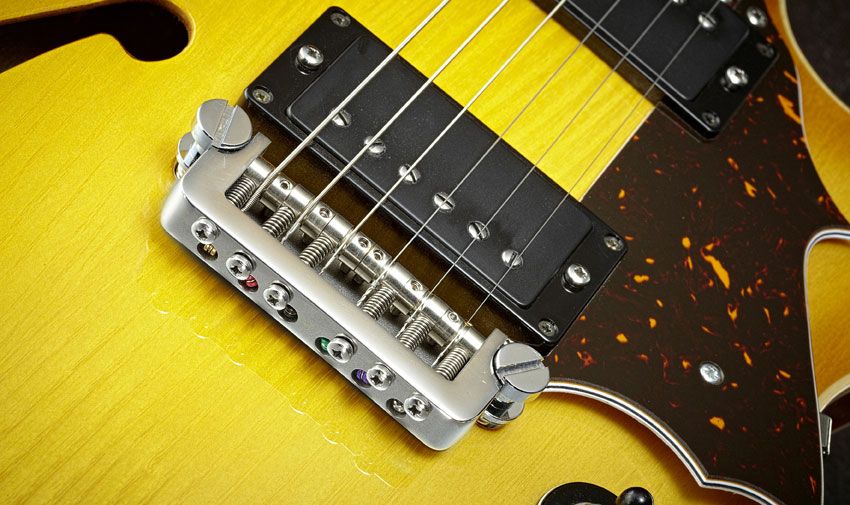 GSG's proprietary bridge design is anchored by two large posts, like a wrapover bridge but featuring six height- and intonation-adjustable saddles