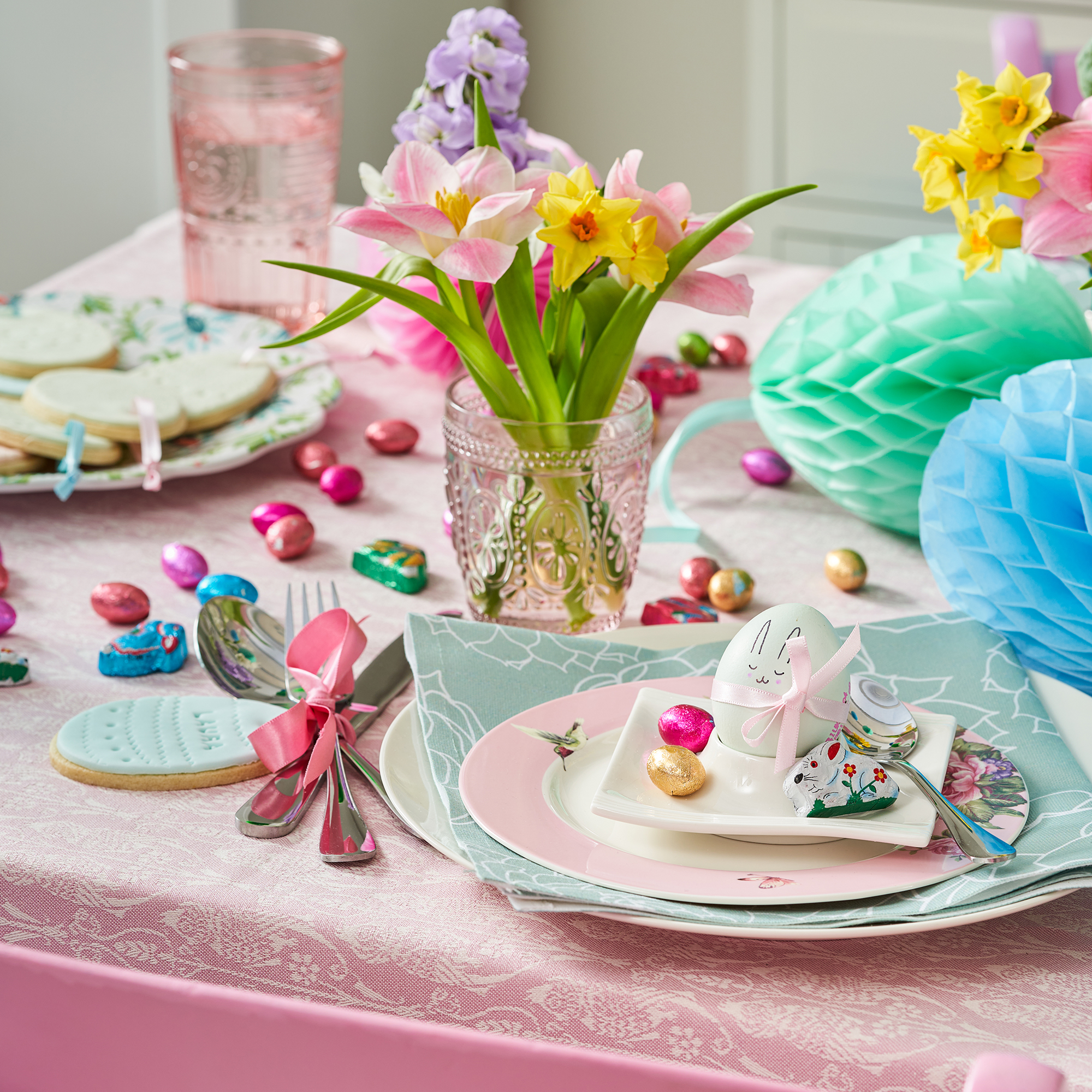 Pretty easter tablescape with colourful mini eggs used as table confetti