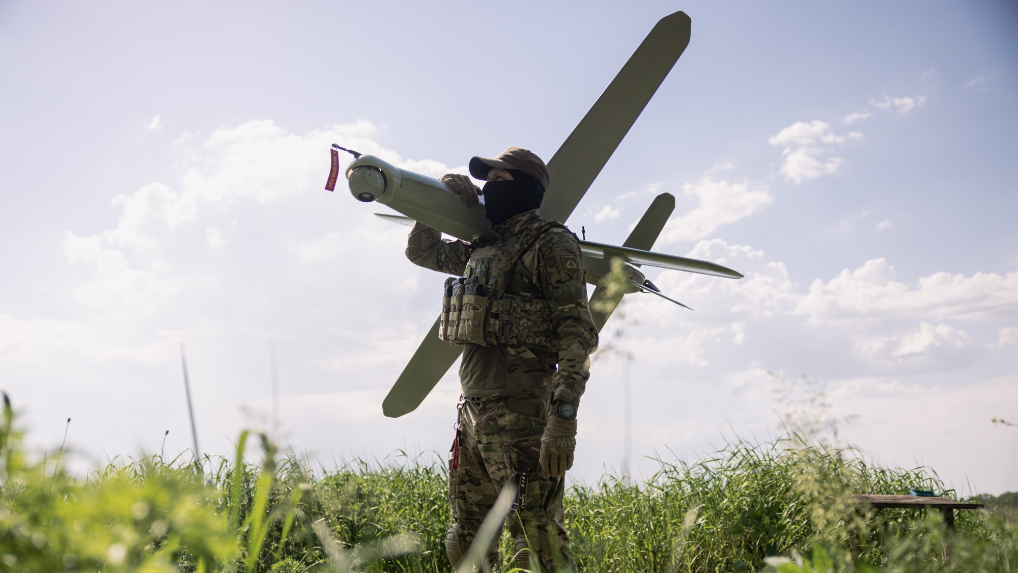 Members of the Lava Unmanned Systems Regiment, Norman, poses for a photograph with a Bulava strike drone, a kamikaze UAV capable of carrying a 3.5-kilogram payload with a range of up to 100 kilometres