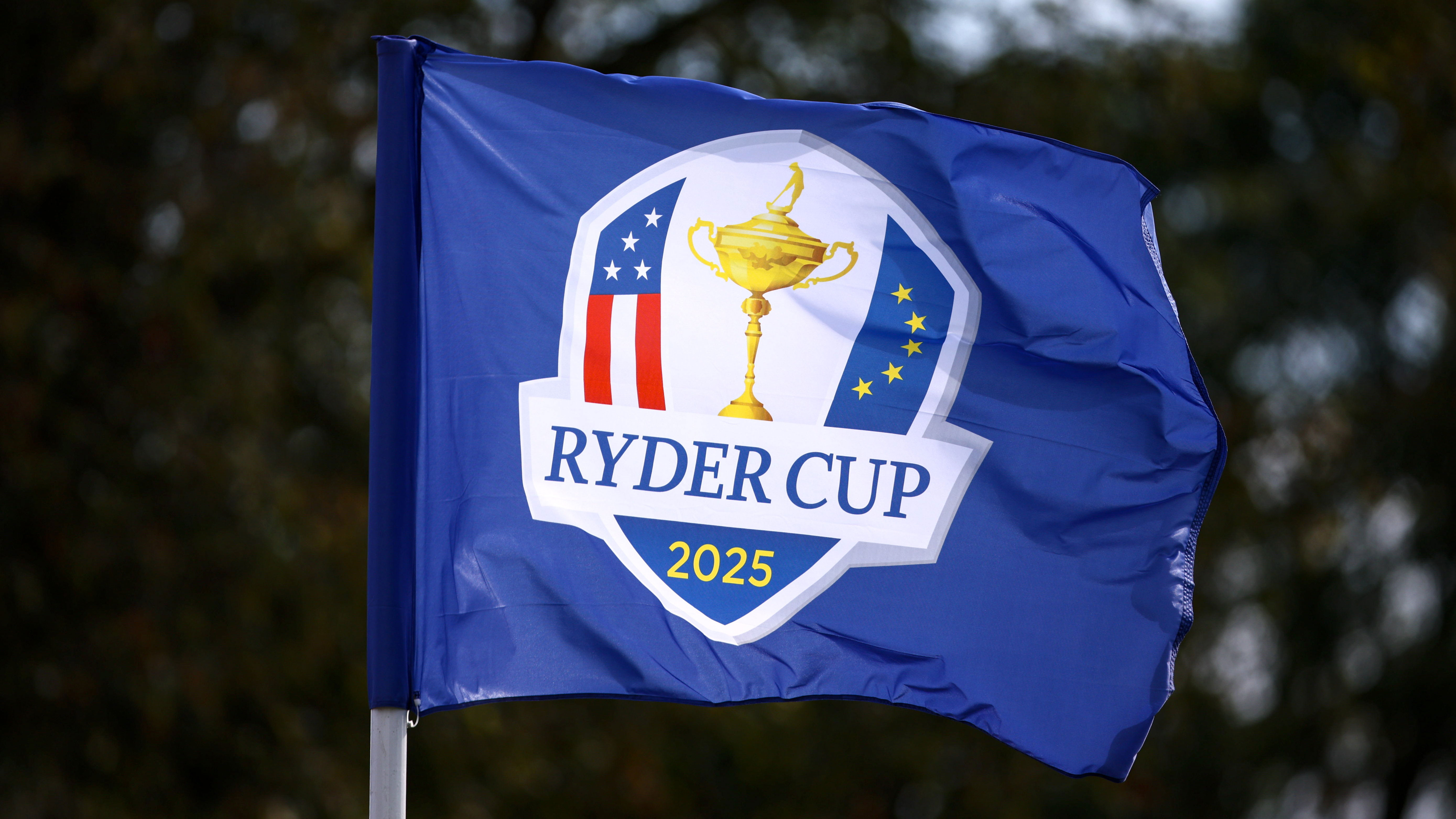 A Ryder Cup flag blowing in the wind with wet weather forecast for Bethpage Black in New York