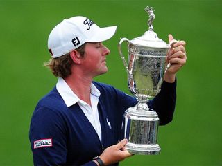 Webb Simpson of the US looks at his championship trophy after winning the 112th US Open at San Francisco's Olympic Club on June 17, 2012 in California. Simpson came from four shots back to win the title overtaking a bunch of big names to win his first major title. The 26-year-old from North Carolina, in just his second US Open, battled back from two early bogeys to grab four birdies in five holes from the sixth and then parred his way down the rest of the back nine for a gripping win. AFP PHOTO/Frederic J. BROWN (Photo credit should read FREDERIC J. BROWN/AFP/GettyImages)
