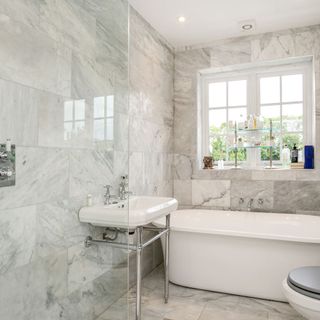 bathroom with bath tub and ceiling marble titles