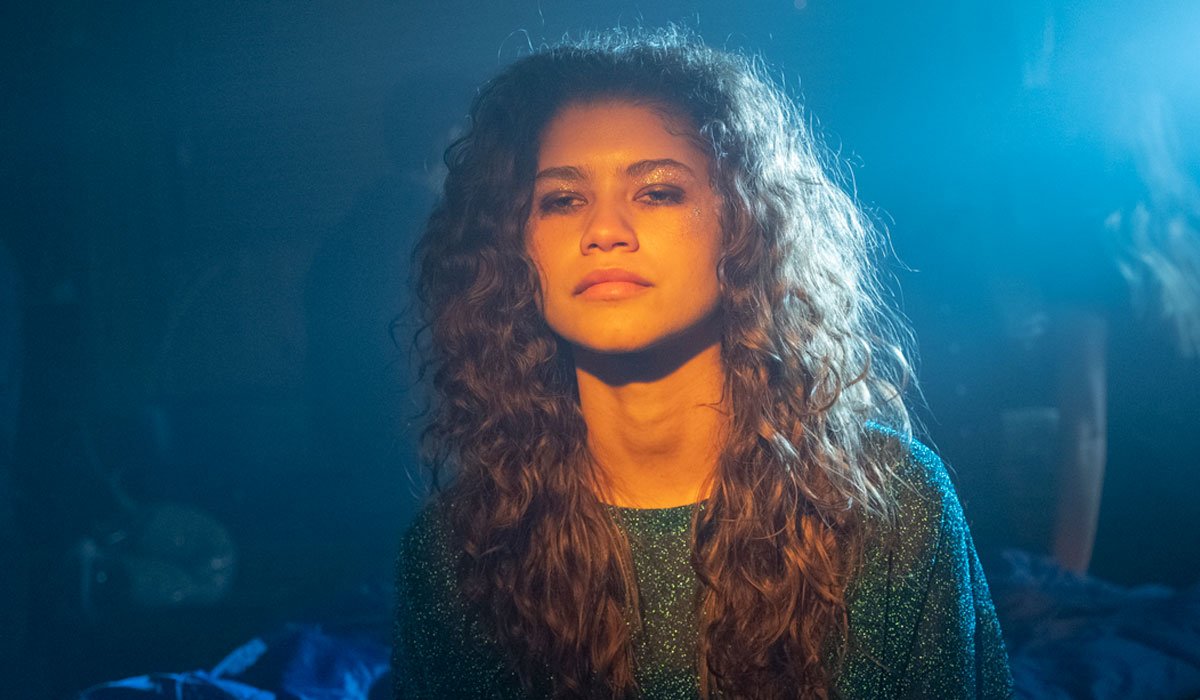 Zendaya staring straight ahead with blue lighting in Euphoria.