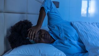 woman struggling with anxiety in bed