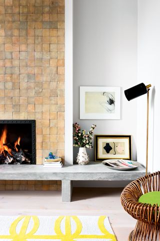 White living room with square tiled fireplace