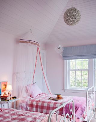 Girls bedroom with pale pink walls and gingham bedding