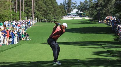 Jon Rahm takes a shot in the fourth round of The Masters