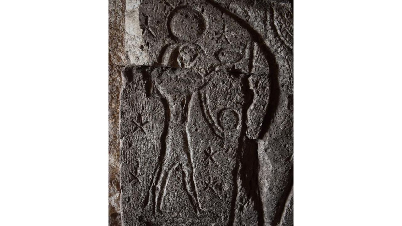 An Egyptian carving of a figure in black stone