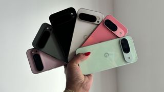 Holding all the different colors of the Google Pixel 9 and Pixel 9 Pro