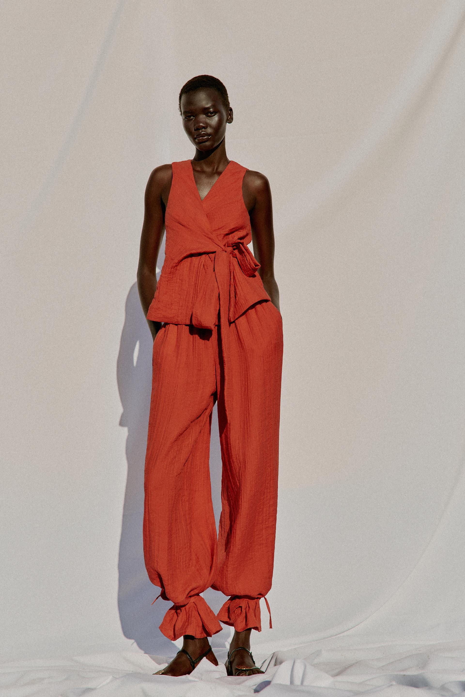 woman wears red zara set with sandals.