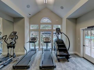 Treadmills and stair masters lined up in a home gym
