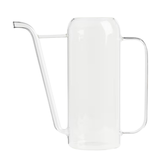 A clear tall glass watering can