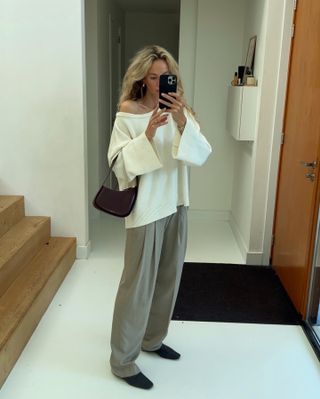 Anouk Yve wearing a sweater and pleated trousers