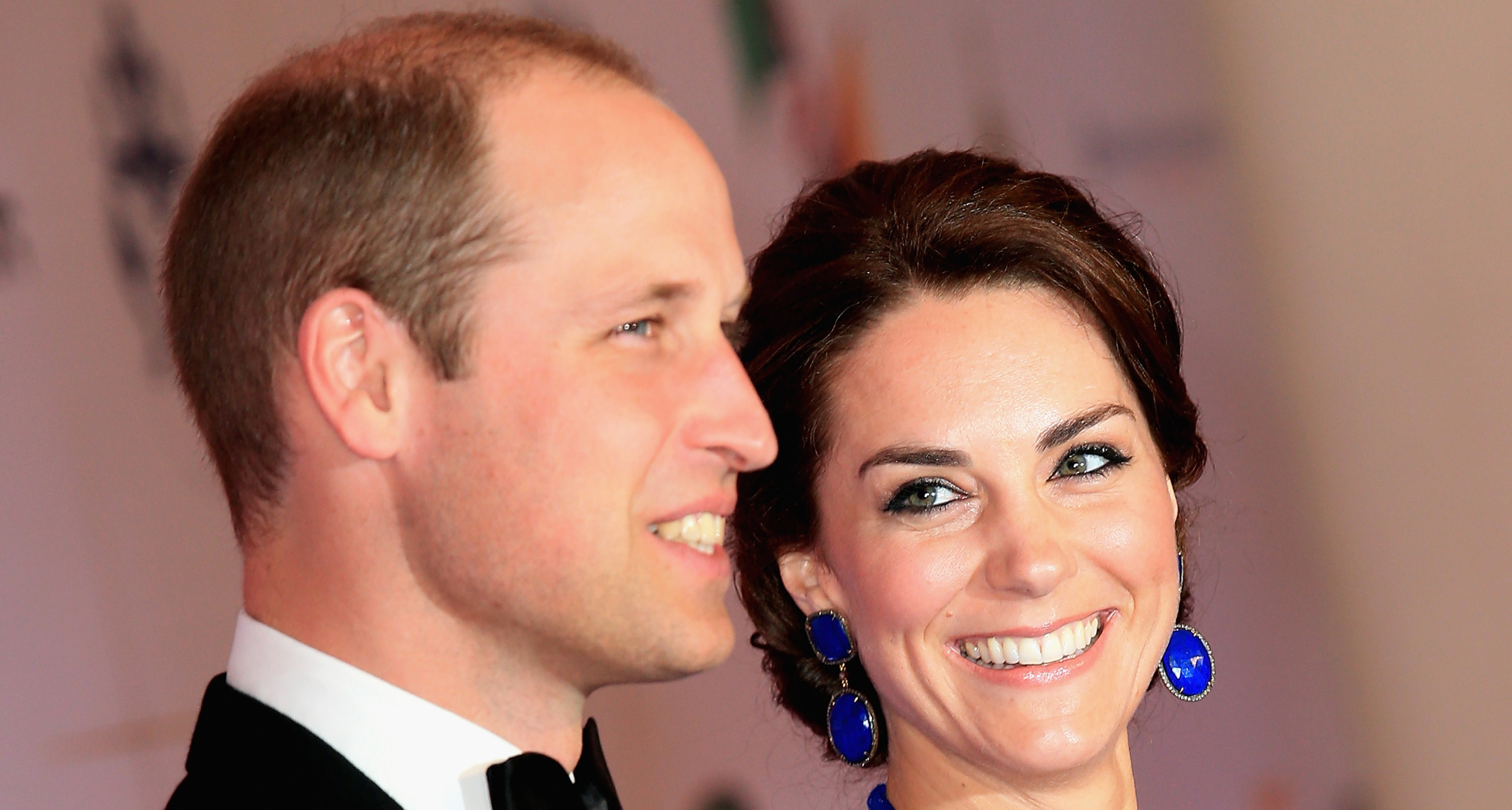 Prince William wearing a tux and Kate Middleton wearing a blue gown in Mumbai