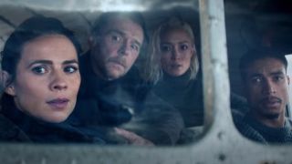 Hayley Atwell, Simon Pegg, Pom Klementiff, and Greg 'Tarzan' Davis look out a plane's window with concern in Mission: Impossible - The Final Reckoning.
