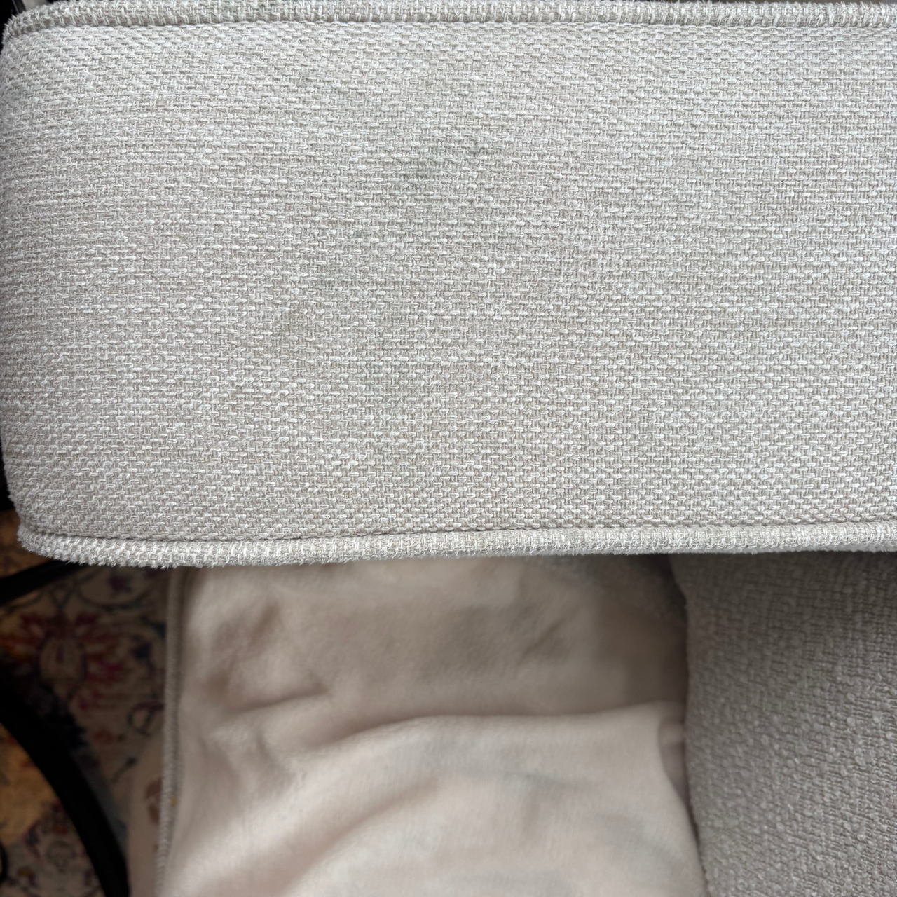 Cream sofa arm with dirt mark before using the Gtech Koala Spot Cleaner