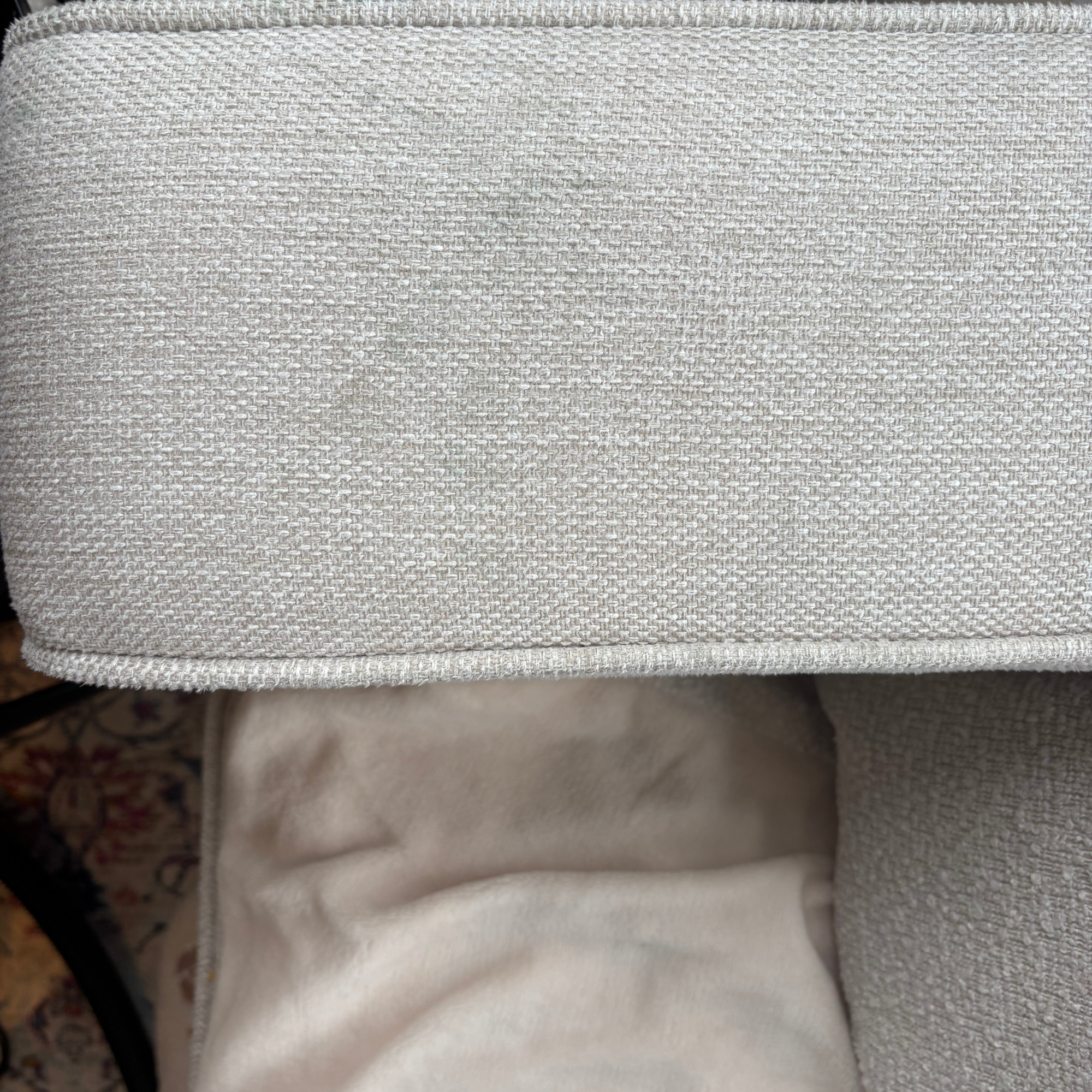 Cream sofa arm with dirt mark before using the Gtech Koala Spot Cleaner